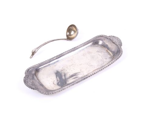 A George III silver oblong snuffers tray and a bird's head sauce ladle. The snuffers tray with a gadrooned border and leaf an