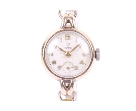 Tudor, a lady's 9ct gold cased round wrist watch on a rolled-gold bracelet. The silvered dial with raised-gilt Arabic numeral