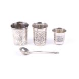 Three 19th century Russian silver and niello beakers and a spoon.