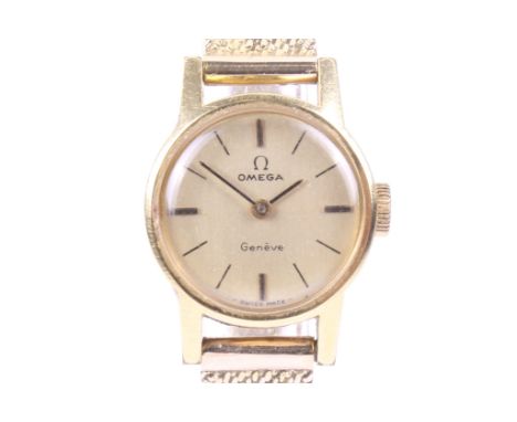 Omega, a lady's gold-plated and stainless steel round wrist watch circa 1969, on a 9ct gold bracelet. The watch with a champa