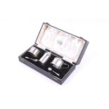 An Art Deco silver faceted-cylindrical three piece cruet set.