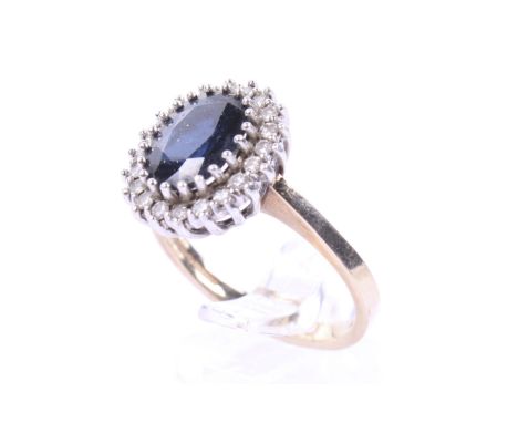 A vintage 9ct gold, sapphire and diamond oval cluster ring. Centred with an oval mixed-cut very-dark-blue sapphire within a s