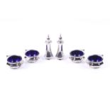 An Edwardian silver six piece cruet set.