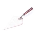 A silver 'foundation stone' trowel with a turned wood handle.