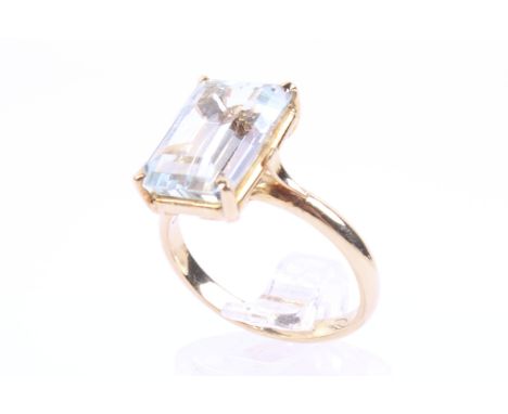 A vintage Continental aquamarine single stone ring. The  rectangular ste-cut pale blue stone in a four-claw setting on a D-se