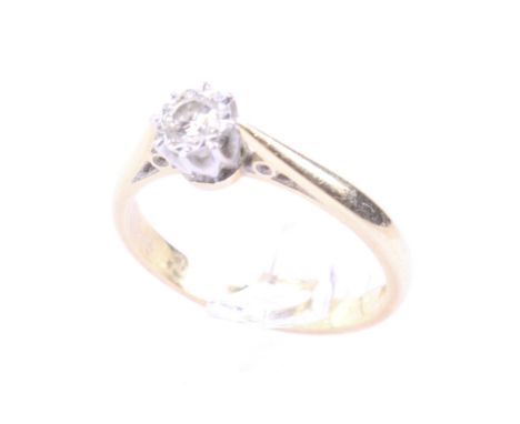 A vintage 18ct gold and diamond solitaire ring. The round brilliant approx. 0.18cts, grain set within an illusion surround on
