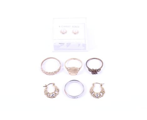 A small collection of jewellery including four rings and two pairs of earrings; Comprising; a 9ct gold open Celtic half-hoop 