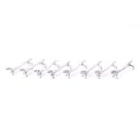 Eight silver knife rests in the form of dachshunds.