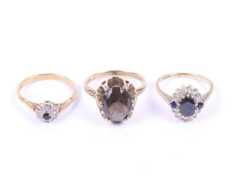 Three gold and gem set dress rings. Comprising; a 9ct gold and sapphire cluster ring, size K, 2.2g gross; a diamond and sapph
