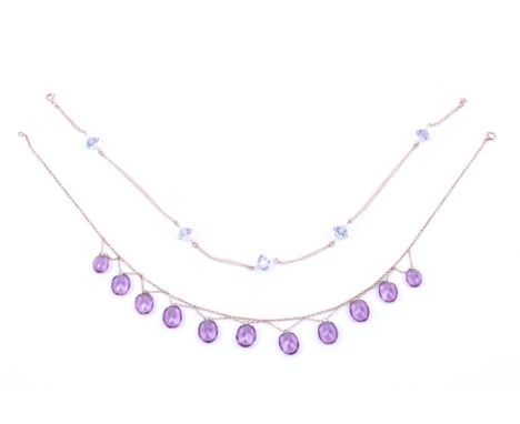 Two gold and 'gem' necklaces. Including an early 20th century gold and amethyst-coloured paste fringe necklace; The eleven gr