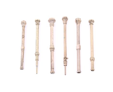 A group of six Victorian and later gilt metal propelling pencils. Each with a floral chased and stone set terminal and a sing