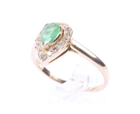 A vintage gold, emerald and diamond pear-shaped cluster ring. Centred with a pear-shaped emerald claw set within round brilli