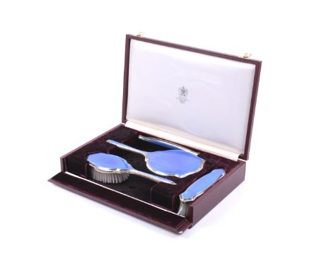 Asprey, a vintage silver and blue guilloche enamelled four piece dressing table set. Comprising a round hand mirror with a sh