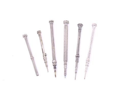 A group of six Victorian and later white metal propelling pencils. Each with a fluted and/or engine turned barrel and a stone