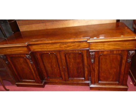 An early Victorian mahogany inverted breakfront sideboard, having three blind frieze drawers over four arched panelled lower 