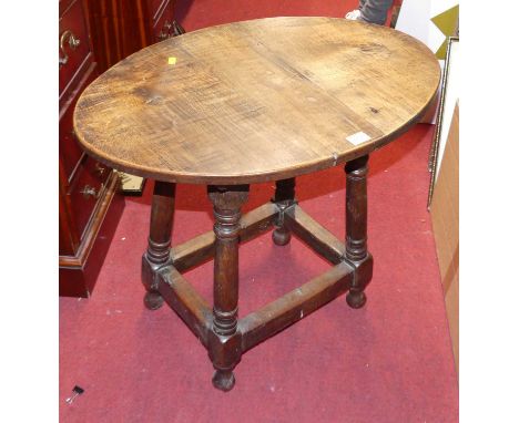A joined oak oval topped low occasional table (adapted from a stool), width 66cm