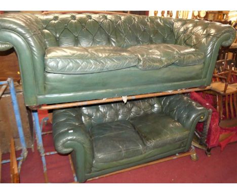 A green leather buttoned upholstered two-piece country house Chesterfield suite, comprising three-seater sofa, w.215cm, and a