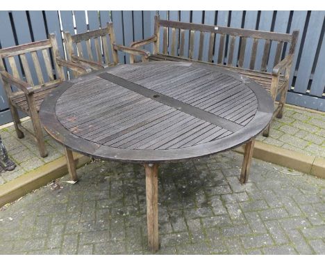 A slatted teak circular garden table, dia.150cm; together with a slatted teak three-seater garden bench; and a pair of slatte