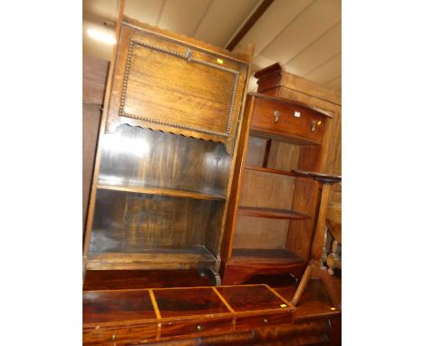 A 1930s oak student's bureau; together with a hardwood bowfront open bookshelf; a lobed pedestal occasional table; and a thre