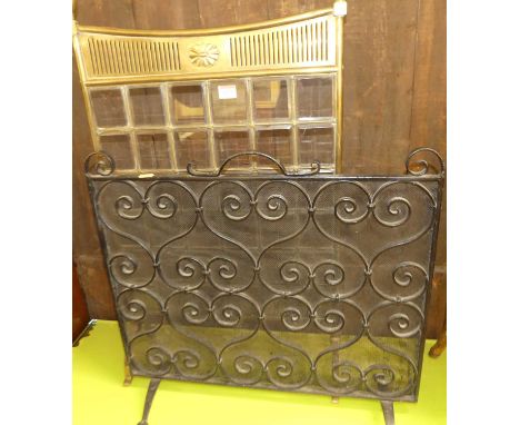 An Edwardian brass and bevelled glass inset firescreen, together with a wrought iron spark guard (2)