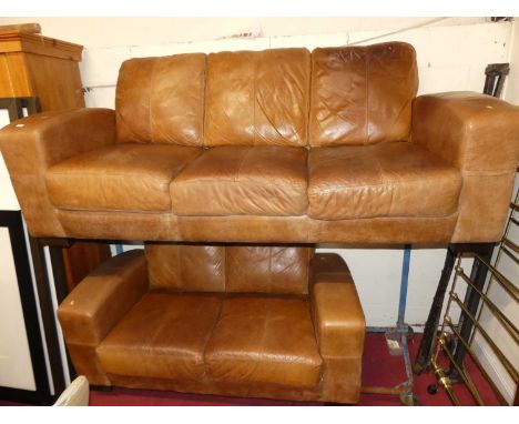 A contemporary tan leather two-piece suite comprising; a three-seater sofa (width 216cm), and a two-seater sofa (width 160cm)