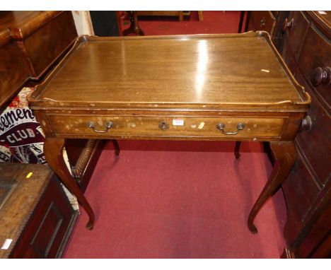 An early 20th century mahogany silver table, the raised edge over a single frieze drawer, to slender cabriole supports, w.85c