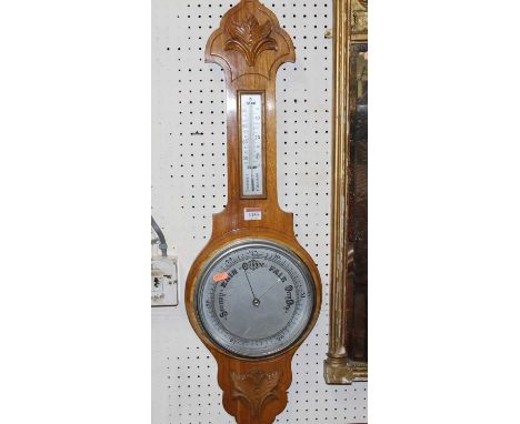 An aneroid oak two dial wheel barometer