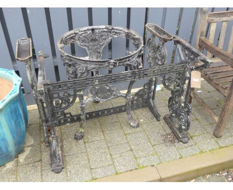 A pair of cast and pierced painted alloy garden table bases, each length 104cm; together with a similar circular pub table ba