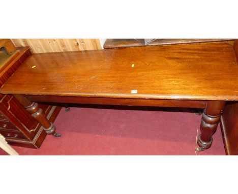 A Victorian mahogany round cornered side table, raised on turned supports, width 153cm