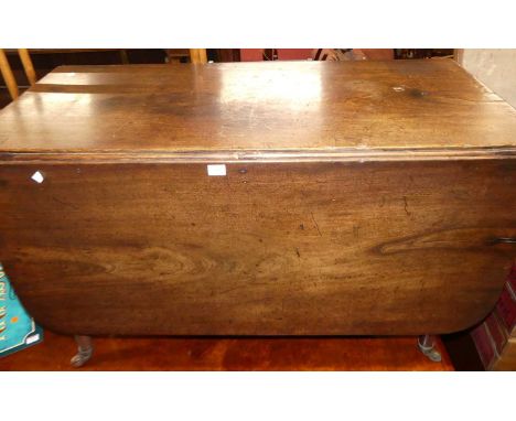 An early 19th century mahgoany round cornered dropleaf dining table, on turned supports