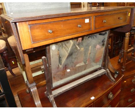 A circa 1900 mahogany drop-end sofa table, having twin frieze drawers, and raised on reeded outswept supports to brass capped