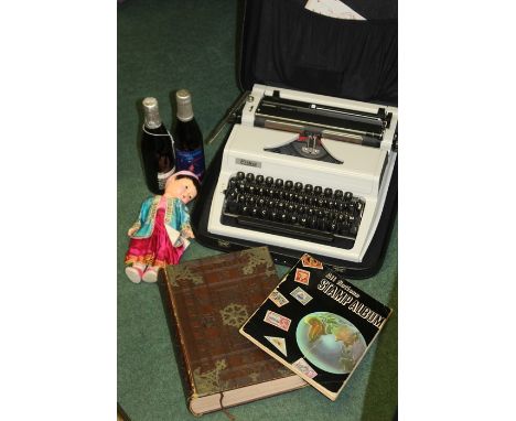 Mixed objects, to include a typewriter, John Smiths Royal Wedding Ale, Anniversary Ale by Courage, stamp album, dolls and The