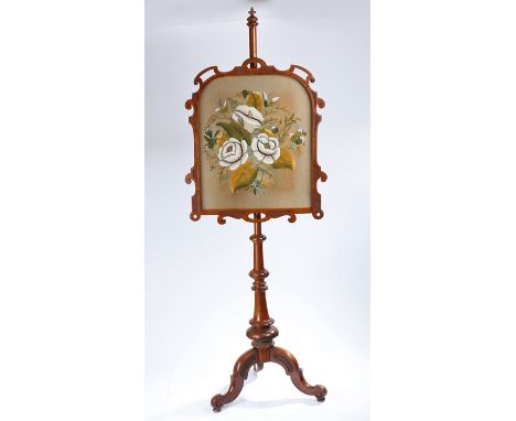 Victorian mahogany fire screen, with a pole above the three cabriole legs, the screen in wool and bead work to form flowers, 
