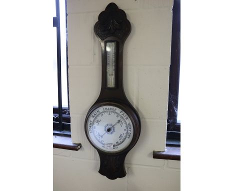 Aneroid barometer/ thermometer, housed in an acanthus leaf carved case, 75cm x 24cm