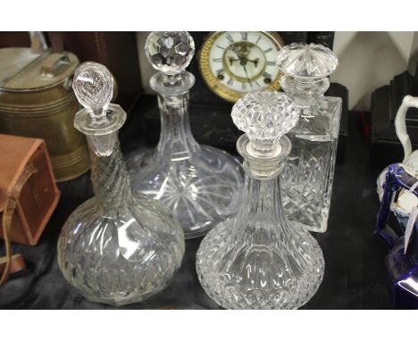 Four cut glass decanters, to include a ships decanter, all with stoppers (4)
