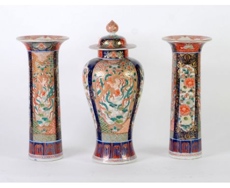 SUITE OF THREE JAPANESE IMARI VASES, comprising; PAIR OF CYLINDRICAL VASES WITH FLARED RIMS AND A BALUSTER VASE AND COVER, DE