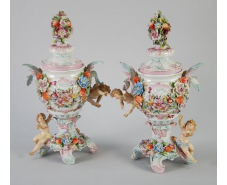 PAIR OF EARLY 20th CENTURY SITZENDORF GERMAN FLORAL ENCRUSTED PORCELAIN VASES AND COVERS, of ovoid form with ornate centre fi