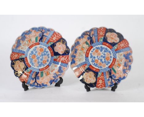 PAIR OF JAPANESE IMARI PLAQUES, decorated with central blue and white flowers, scalloped rims, six character marks to base, 9