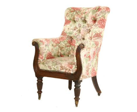 A William IV mahogany and button upholstered armchair,with scrolling reeded show frame and on turned and fluted front legs, t