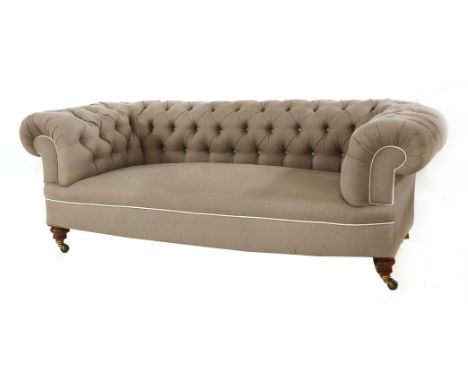 A pair of button-backed chesterfield settees,late 19th/early 20th century, each upholstered in grey and on ring turned legs, 