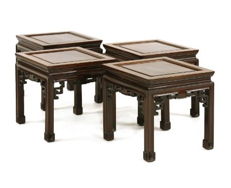 A set of four Chinese padouk occasional tables,20th century, each with pierced and carved supports, and on scroll feet,42cm w