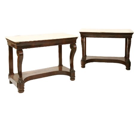 A pair of mahogany console tables, 19th century, each with white handle tops, one repaired, raised on plain scrolled supports