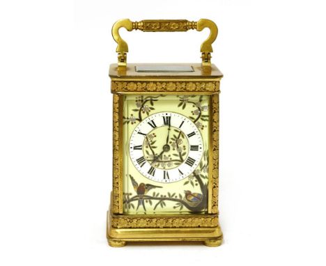 A French gilt brass and porcelain-mounted carriage clock,late 19th/early 20th century, the shaped handle over a porcelain dia