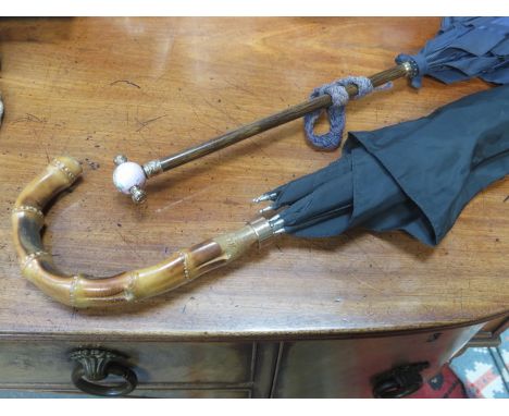 TWO VINTAGE PARASOLS BOTH WITH GOLD COLOURED MOUNTS 