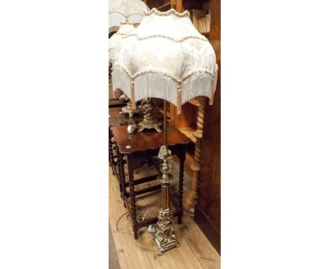 A polished brass effect and glass small lamp standard with patterned cream fringed shade 