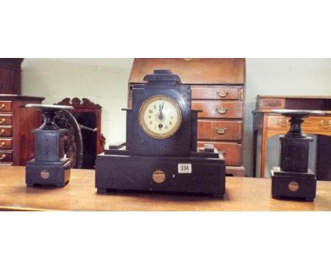 A three piece black marble clock garniture 