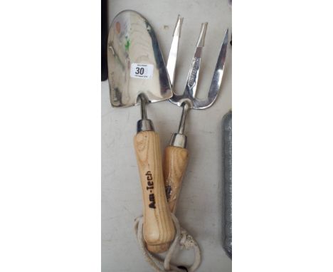 A stainless steel garden hand trowel and hand fork 