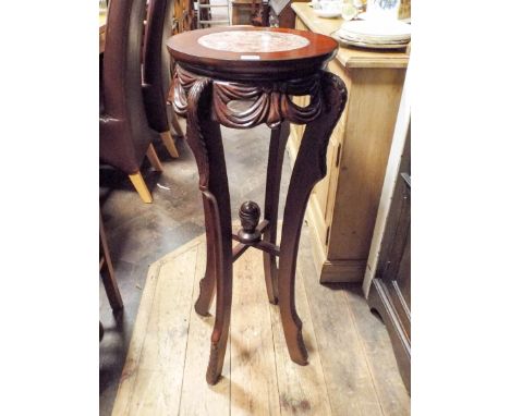 A reproduction mahogany plant pedestal with inset tile marble top 