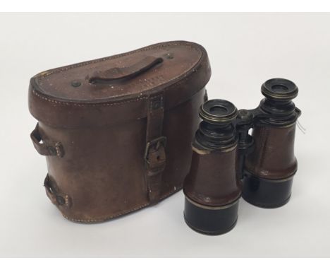 A pair of French WWI Binoculars in a mismatched British WW1 leather case. To include: Binoculars marked with an arrow and MG 