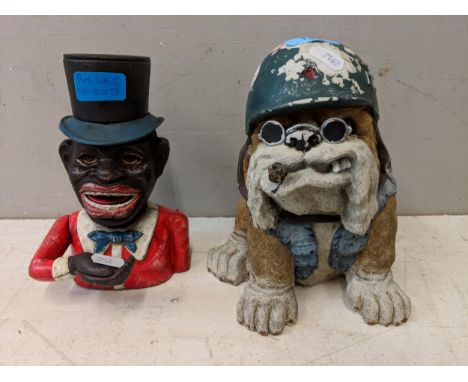 A cast metal money bank in the form of an out dated depiction along with a novelty model of a British Bulldog wearing a WWII 